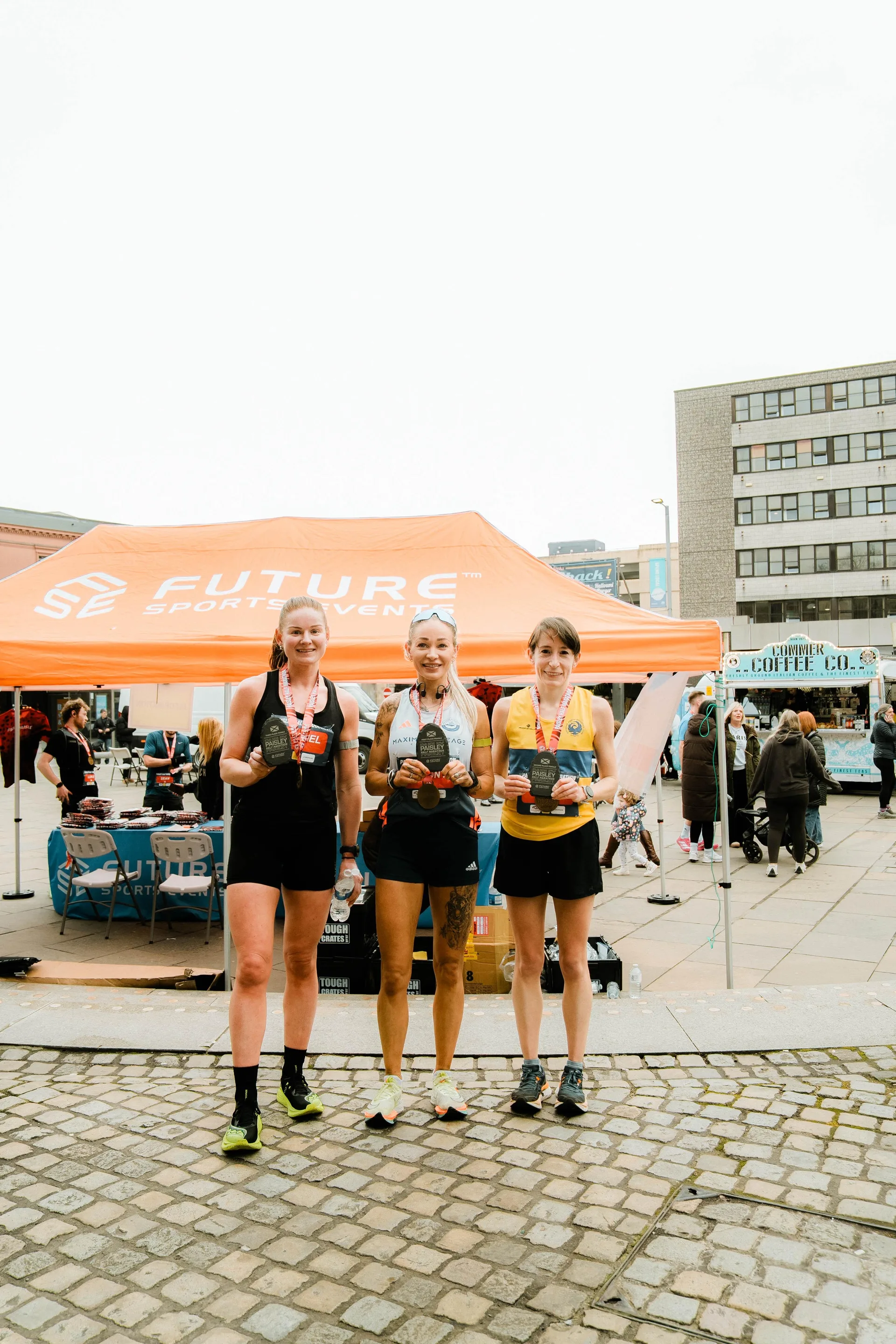 Runners celebrating at the Future Sports tent