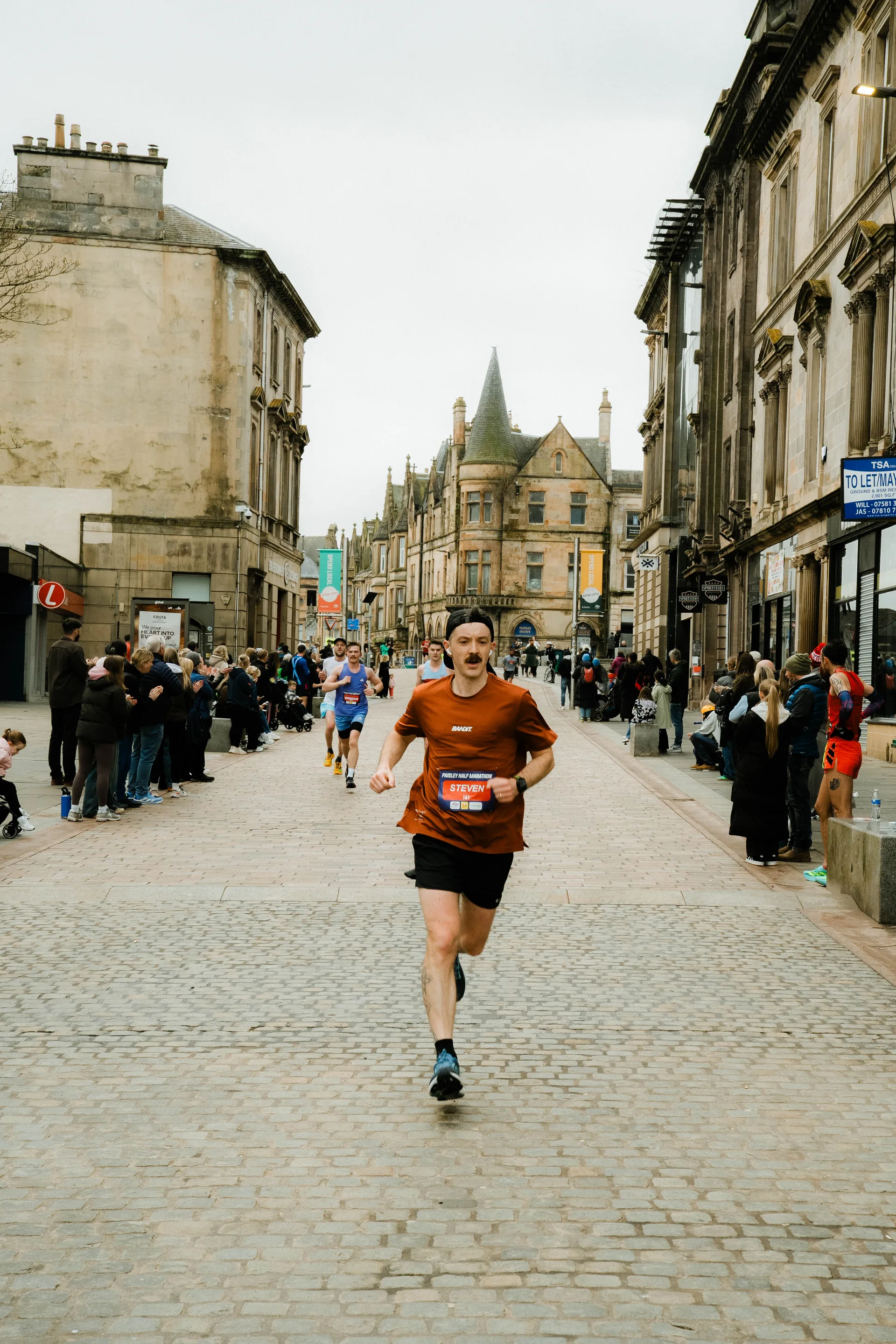 A runner approaching through Paisley town centre