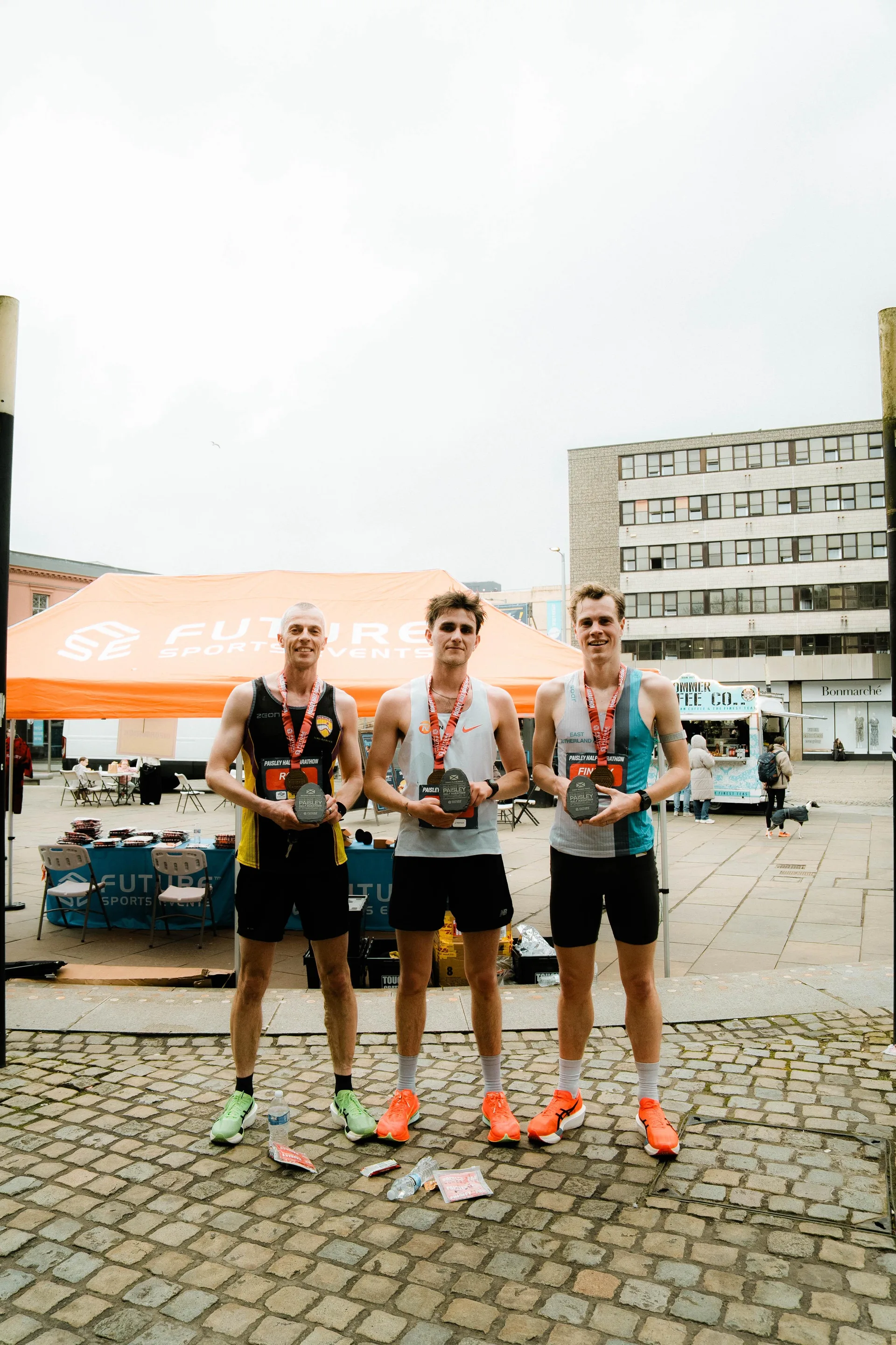 Runners together beside the Future Sports tent